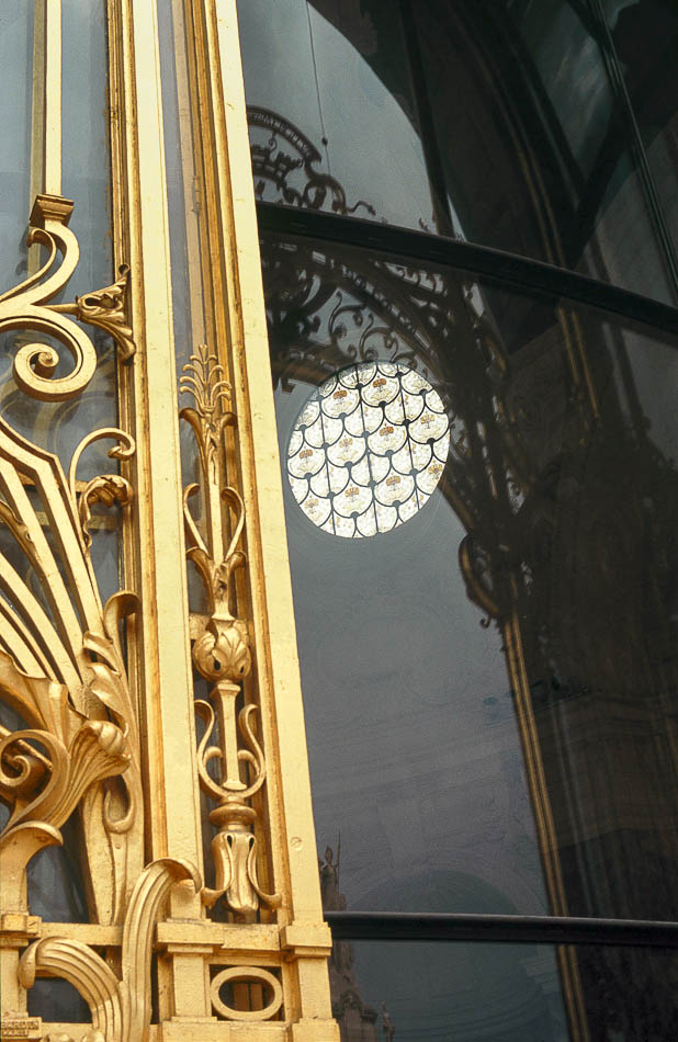 Paris - Golden door of the small palace with a circular stained glass window