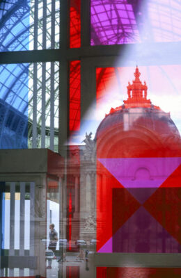 Reflection of the dome of the Petit Palais (small palace)seen in the blue, red and purple colored windows of the Grand Palais (big palace) - Paris
