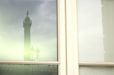 Place Vendôme (square Vendôme)first arrondissement in Paris. Photo of a window reflecting the column in Place Vendôme (square Vendôme)
